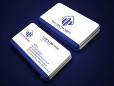 two white and blue business cards on a dark background