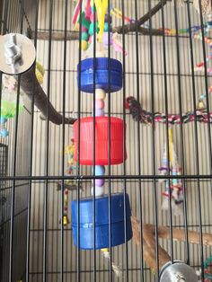 a bird cage filled with lots of toys