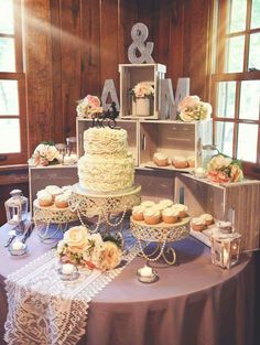 a wedding cake and cupcakes on a table