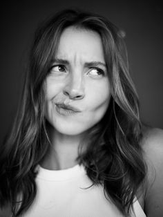 a black and white photo of a woman making a funny face