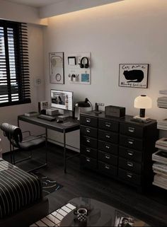 an office with black and white decor in the corner