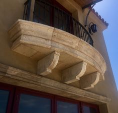 a balcony with two balconies on the side of it and a red door