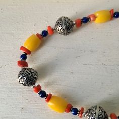 "Yellow glass bead necklace 3 large silver beads with raised design Small red and blue beads 20\" long Yellow beads .5\" long , .26\" wide Condition - very good vintage" Red Fringe, Red Beads, Hippie Necklace, Necklace Boho, Red Bead, Glass Bead Necklace, Blue Beads, Boho Necklace, Small Designs