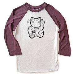 "The waving cat on this super cute tee waves good luck your way! Maneki Neko are popular good fortune cats adored in Japan, and you'll see them outside many shops, attracting good fortune and prosperity. These two-color unisex raglan shirts are made of a lightweight, buttery-soft polyester/cotton blend, and are amazingly comfortable! The 3/4 length sleeves hit just below the elbow, with contrast color sleeves for a stylish colorblock look. ☆ Sizing in inches is as follows ☆ XS - width across che White Long Sleeve T-shirt With Cat Design, White Long Sleeve Top With Cat Design, Kawaii Long Sleeve Top With Cat Design, Long Sleeve Cotton T-shirt With Cat Design, Casual Long Sleeve T-shirt With Hello Kitty Print, Casual Long Sleeve Hello Kitty T-shirt, Kawaii Long Sleeve Tops With Cat Print, Kawaii Long Sleeve Cat Print Top, Waving Cat