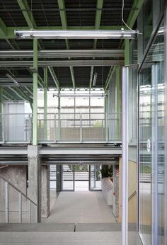 an empty building with glass walls and stairs