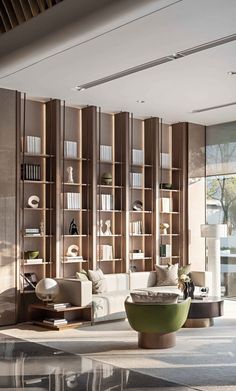 a living room filled with furniture and bookshelves next to a wall mounted book case