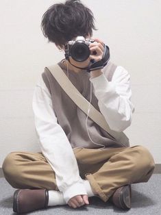 a person sitting on the floor with a camera