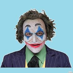 a man with clown makeup on his face wearing a suit and tie, against a blue background