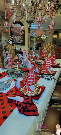 the table is set with red and black decorations