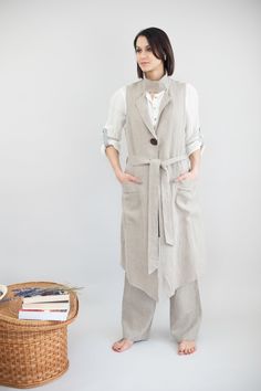 Elegant and comfortable women linen jacket is sewn from highest quality Lithuanian softened linen. This unique design linen jacket is perfect to be worn on everyday basis, as well as for some special occasions as an addition to your outfit. This comfortable to wear, exclusive and high quality long jacket is sleeveless and has clasp in the front as well as big decorational button. Linen cardigan can fastened with a belt. It also has two wide pockets, each on both sides of a jacket. Decoration col Summer Linen Outerwear With Pockets, Beige Linen Dress For Workwear, Beige Linen Dress For Work, Relaxed Fit Linen Outerwear, Linen Dress With Pockets For Workwear, Fall Workwear Linen Dress, Fall Linen Dress For Work, Beige Linen Dress With Pockets, Spring Linen Lagenlook Dress