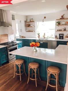 a kitchen with blue cabinets and white counter tops