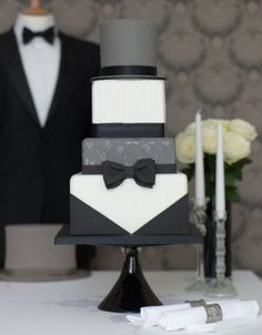 a black and white wedding cake sitting on top of a table