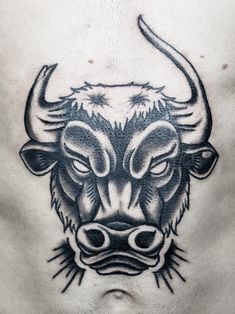 a bull's head tattoo on the chest