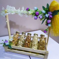 a wooden tray filled with nuts and flowers