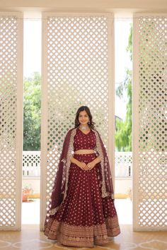 Wine Dyable Viscose Jacquard Lehenga Set is perfect for any occasion. The double zari work in the flair adds a touch of elegance, making it ideal for weddings, festivals, and other special events.  Highlights: Lehenga: Crafted from Pure Dyable Viscose Jacquard, this stitched lehenga offers a luxurious texture and a rich wine color. With a length of 42 inches and a 3.5-meter flair, it creates a graceful silhouette. The cotton inner lining ensures comfort, while the chain closure with dori latkan adds a traditional and secure fit. The stitching with can-can and canvas-patta enhances its structure and elegance. Blouse: The set includes a matching stitched blouse made from Dyable Pure Viscose Jacquard, measuring 1 meter in length. It complements the lehenga, allowing you to create a harmonious Luxury Jacquard Dupatta With Zari Work, Luxury Jacquard Dupatta For Wedding, Luxury Traditional Jacquard Dupatta, Luxury Jacquard Wedding Dupatta, Jacquard Lehenga, Stitched Lehenga, Zari Work, Wine Color, Festival Wedding