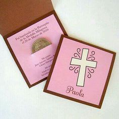 a pink and brown card with a cross on the front, and a coin in the back