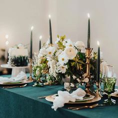 the table is set with candles and flowers