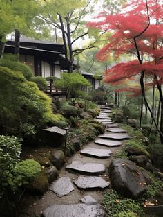 a stone path in front of a house surrounded by trees