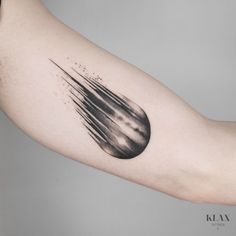 a black and white tattoo on the arm of a person with an inked design