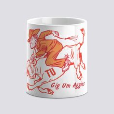 a white coffee mug with an orange and red graphic on it