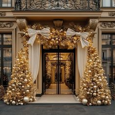 an entrance decorated with gold and white christmas decorations