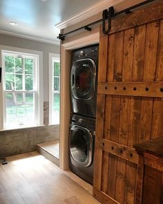 a washer and dryer are in an empty room