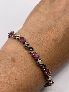 This pink red Tourmaline bracelet is very lively and bright.  The stones are deep colors and well matched.  The sterling silver oxidized with age  7.5 inches  My jeweler can shorten this for a $20 fee All jewelry is shipped in a nice gift box.   Check out our over a THOUSAND great reviews Engraving is $4 per letter and is not always perfect depending on the piece. It can take a few days if the jeweler is busy. This is payable to Paypal Judithsltd@gmail.com Pink Ruby Round Bracelets, Formal Pink Ruby Bracelets, Formal Pink Ruby Bracelet, Pink Ruby Bracelets With Gemstone, Pink Gemstone Sterling Silver Bracelet, Elegant Pink Tourmaline Bracelets, Silver Tennis Bracelet, Red Tourmaline, Lock Style