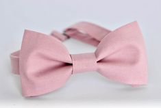 This trendy and stylish bow tie is great for so many occasions! Bow tie made of 100% cotton with a matching, adjustable neck strap. Style: * The Pre-Tied Bow Tie (with an adjustable neck strap) * The Clip-On Bow Tie (strapless, just a clip that you attach to the shirt collar) * Pocket square (handkerchief) All our bow ties can be made in the following Sizes: Baby: 3.5" x 2" Kids: 4" x 2" Youth: 4.5" x 2.25 Adult: 5" x 2.5" All our bow ties are made by hand; therefore, measurements are a guidelin Pink Bow With Bow Tie Back For Wedding, Pink Formal Bow With Bow Tie Back, Elegant Pink Bow For Black Tie Events, Pink Elegant Bow Tie With Decorative Bow, Elegant Pink Bow Tie With Decorative Bow, Pink Satin Bow For Black Tie Events, Pink Satin Bow Tie For Wedding, Elegant Pink Bow Tie For Suits, Adjustable Pink Bow For Wedding