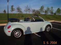 a white convertible car parked in a parking lot