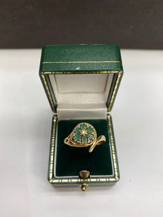 This feminine floral emerald & diamond ring is crafted in the warm hue of 9 carat yellow gold. Ring size: R New Insurance Price: £465.00 Green Cluster Ring With Rose Cut Diamonds, Elegant 14k Stamped Emerald Ring, Victorian Emerald Ring In Yellow Gold Stamped 14k, Victorian Emerald Ring In 14k Yellow Gold, Luxury Yellow Gold Emerald Ring With Rose Cut Diamonds, Yellow Gold Multi-stone Emerald Ring For Gift, Emerald Ring With Rose Cut Diamonds For Formal Occasions, Green Cluster Ring With Diamond Accents For Gift, Green Cluster Ring With Diamond Accents As Gift