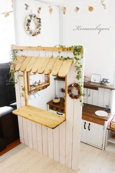 the inside of a small wooden building with plants growing on it