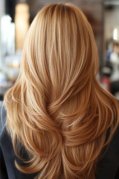 Back view of blonde hair with soft, flowing layers styled neatly.