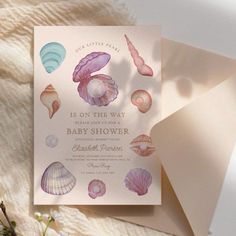 the baby shower is decorated with seashells and pink watercolor paint on paper