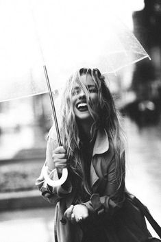 a woman holding an umbrella in the rain