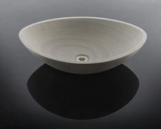 a white bowl sitting on top of a black table