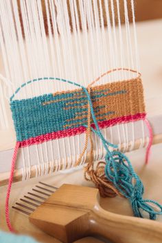 a weaving machine with yarn and wooden combs