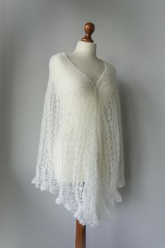 a white lace shawl on a mannequin