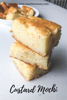 three pieces of cake sitting next to each other on a white table with a bowl of food in the background