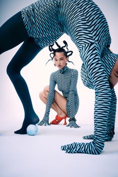 a woman in zebra print is kneeling down