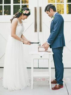 a bride and groom cutting their wedding cake