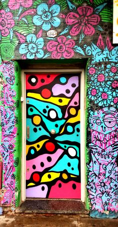 a colorful door is painted on the side of a building