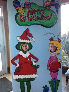 a cardboard christmas sign with two children dressed as santa claus and mrs griner on it