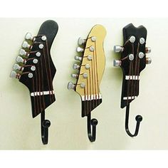 three guitars are hanging on the wall and there is also an ebay advertizer