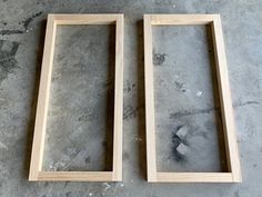 two wooden frames sitting on top of a cement floor next to each other, with one missing