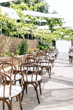 tables and chairs are lined up outside in the shade