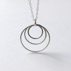 Silver Circle Necklace Three Ring Pendant Circles Geometric Hoop Necklace Handmade womens Jewelry gi Modern Circle Stainless Steel Jewelry, Modern Silver Full Circle Jewelry, Modern Silver Round Disc Jewelry, Modern Round Sterling Silver Jewelry, Modern Sterling Silver Open Circle Jewelry, Nickel-free Open Circle Jewelry Gift, Cadmium-free Sterling Silver Minimalist Jewelry, Modern Everyday Round Disc Jewelry, Cadmium-free Minimalist Sterling Silver Jewelry