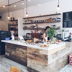 a man standing behind a counter in a restaurant