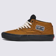 a brown and black high top sneaker with white laces on the outstep