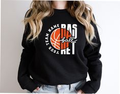 a woman wearing a sweatshirt that says team name basd and basketball on the front