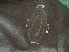 the letters o are drawn on a t - shirt that is being sewned